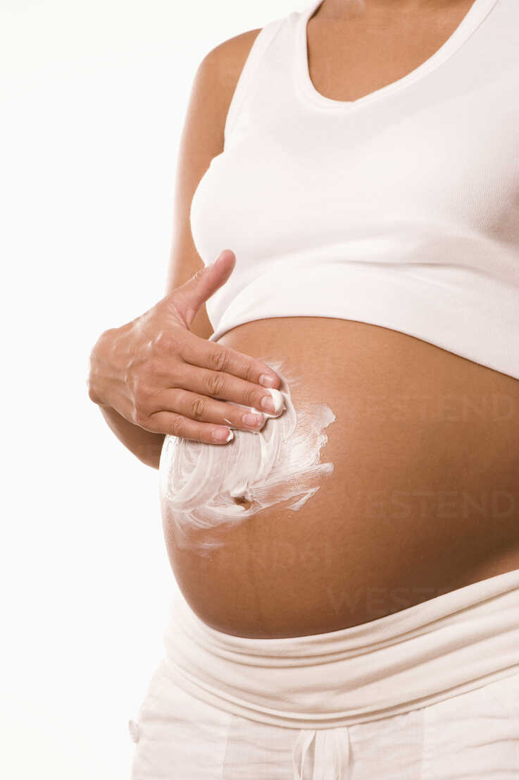 Pregnant Woman Body Lotion On Belly Midsection Stockphoto