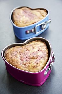 Two Heart Shaped Cake Pans Of Strawberry Pound Cake On Grey Ground Stockphoto