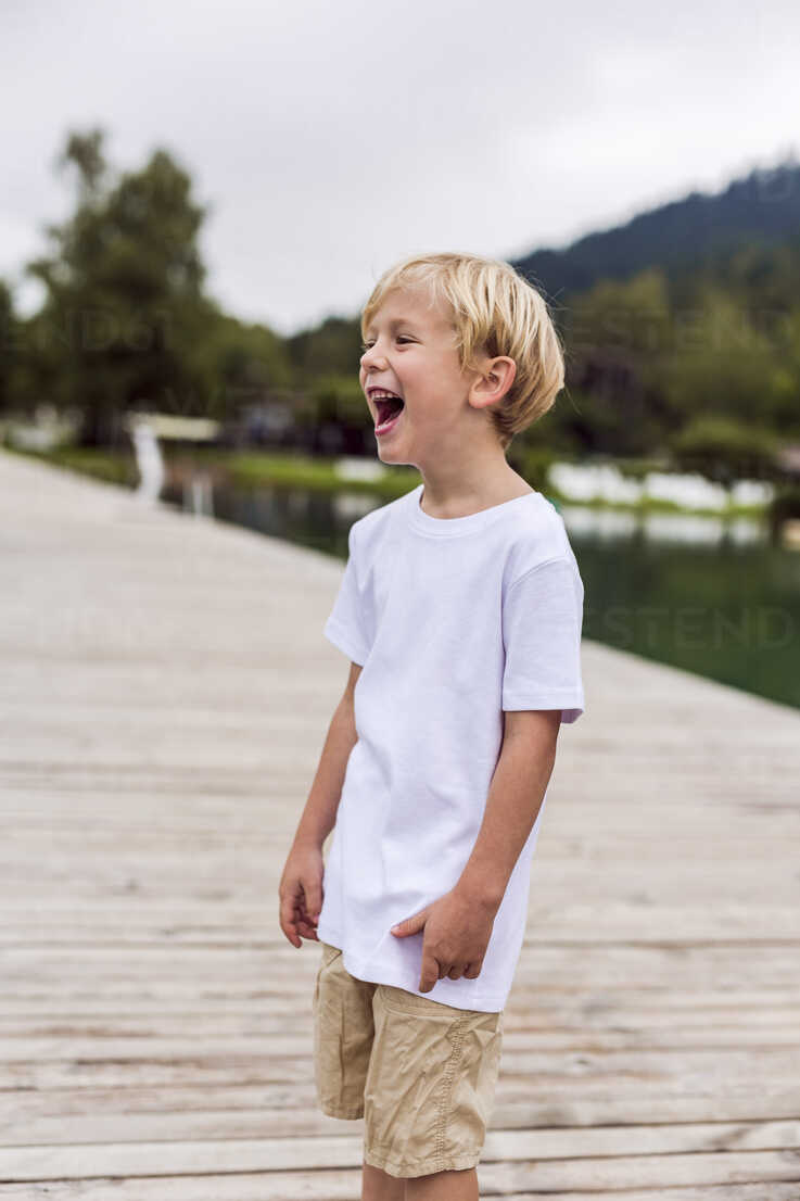 Boy Walking On A Wooden Foot Bridge On A Lake Stock Image 