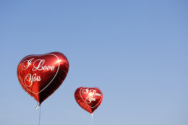 Two Red Heart Shaped Balloons In Front Of Blue Sky Stockphoto