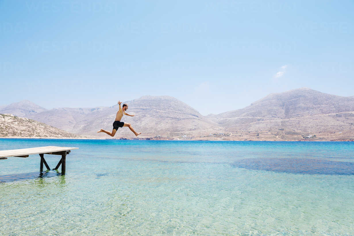 Greece Cyclades Islands Amorgos Aegean Sea Naked Man Jumping From A Wooden Jetty Gemf Gemma Ferrando