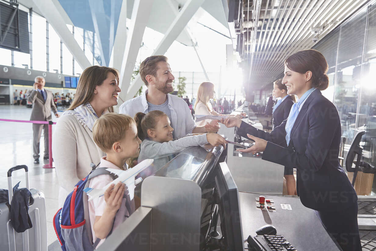 Customer Service Representative Checking Family Tickets At Airport Check In Counter Caif Chris Ryan Westend61