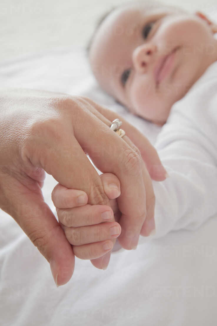 Download Mothers Hand Holding Baby Boys Hand Stockphoto