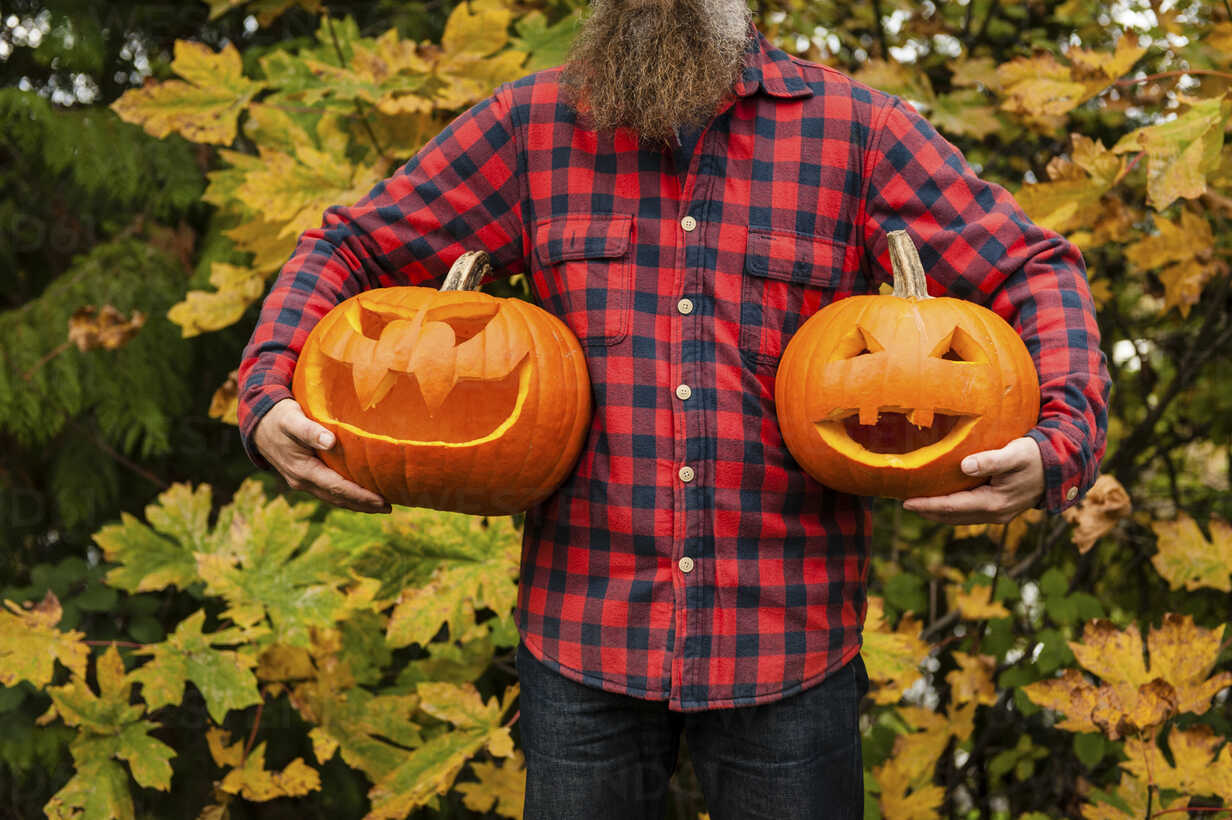 Mature Man Holding Carved Pumpkins Stockphoto