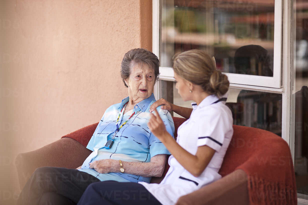 Care Assistant Chatting To Senior Woman On Sofa Cuf Zero Creatives Westend61