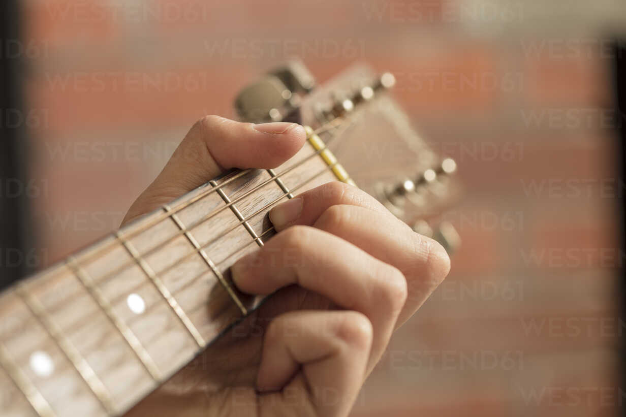 Close Up Of Man S Hand Playing Guitar Stockphoto