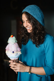 Stylish Young Woman In Blue Knit Hat Holding Large Ice Cream Cone Stockphoto