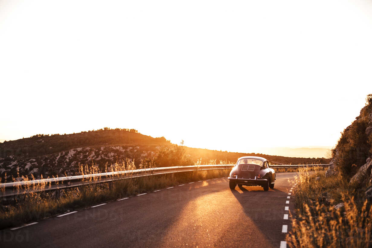 Spain Classic Car Driving On Road During Sunset Stockphoto