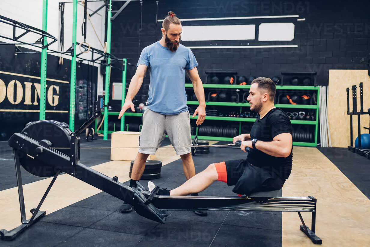 Personal Trainer Working With Man With Disability In Gym Cuf Eugenio Marongiu Westend61