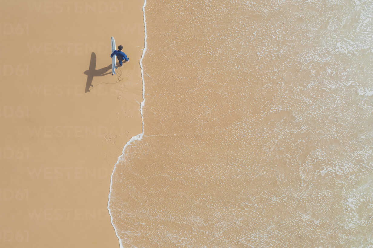 Portugal Algarve Sagres Praia Da Mareta Aerial View Of Man Carrying Surfboard On The Beach Mmaf