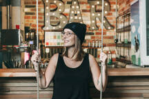 Smiling Woman Sitting On A Swing In A Hotel Bar Naf Sinanmuslu Westend61