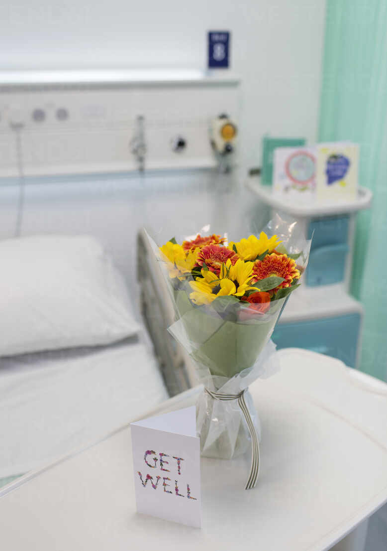 Flower Bouquet And Get Well Card On Tray In Vacant Hospital Room Stockphoto