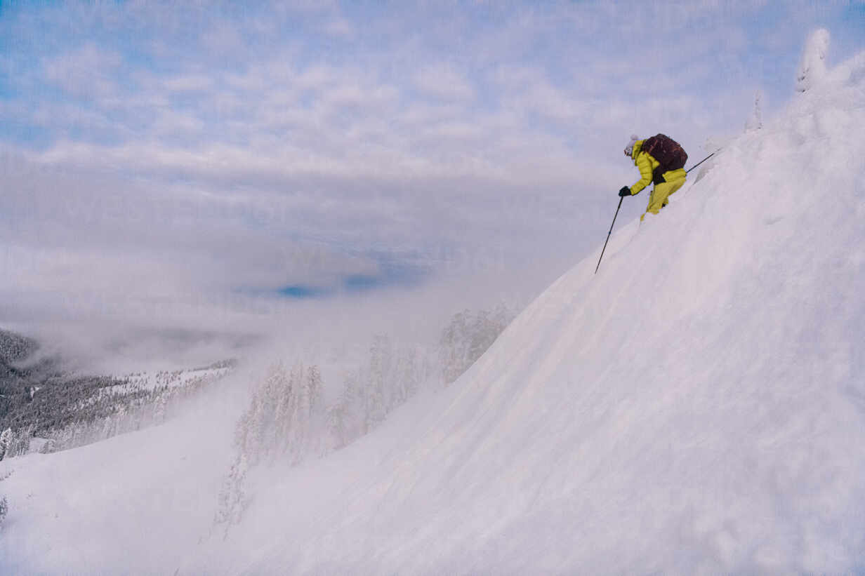 Person Skiing Downhill A Steep Slope Of Virgin Powder Snow In A Wintry Landscape Isf Alex