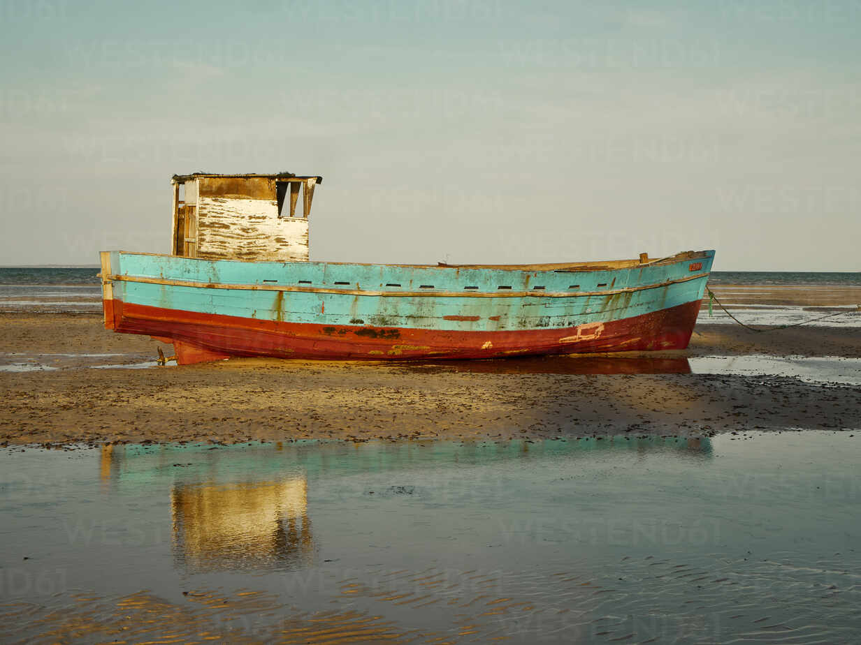 Abandoned Fishing Boat Moored On Shore At Beach Against Sky Vegf Veam Westend61