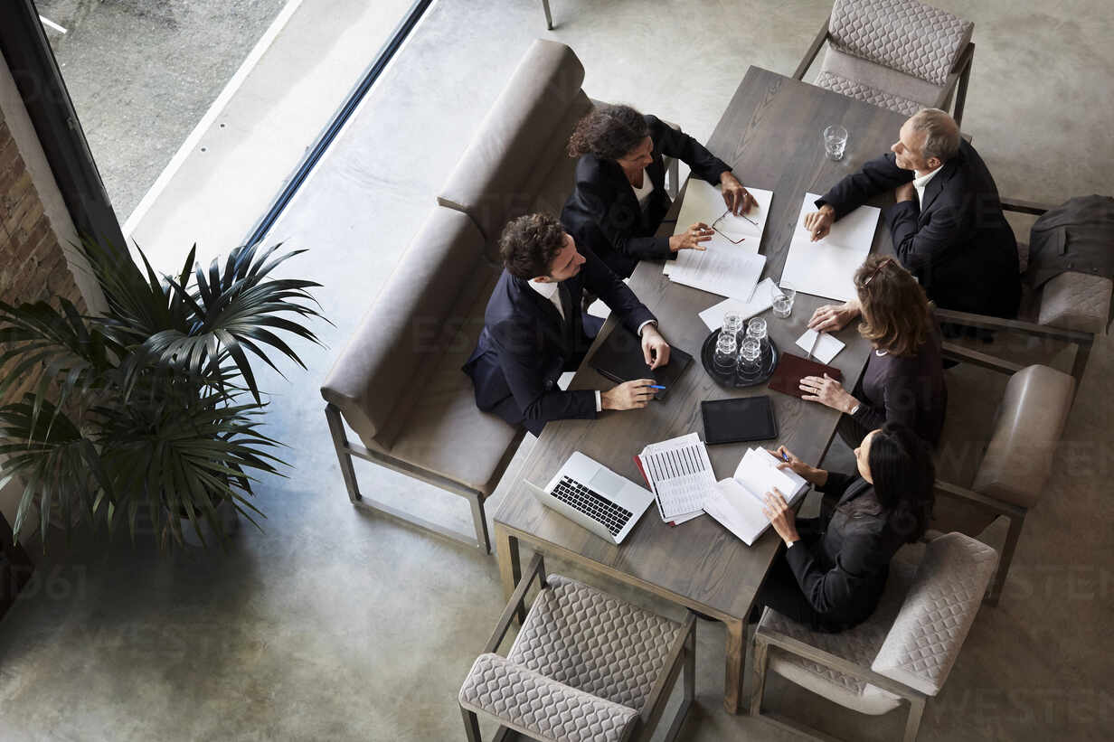 Team Of Lawyers Planning With Business Colleagues During Meeting At Law Firm Stockphoto