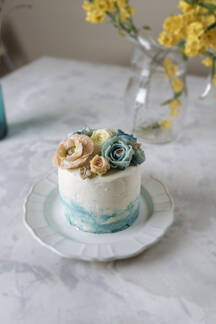 Buttercream Flowers Cake Blue And Pastel Peach Colors On The Table Stockphoto