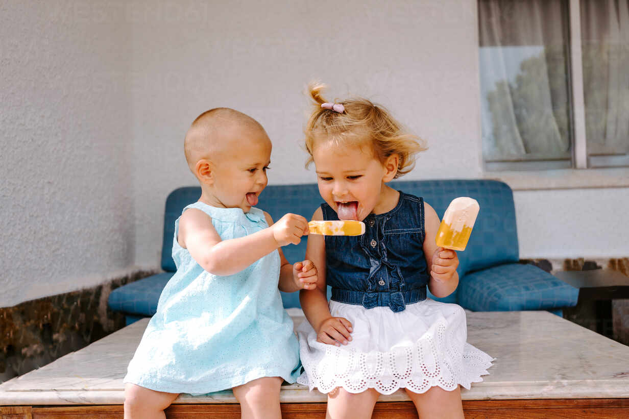 Cute Little Girls Eating Yummy Popsicles While Enjoying Summer And Sitting Together In Backyard Adsf Addictive