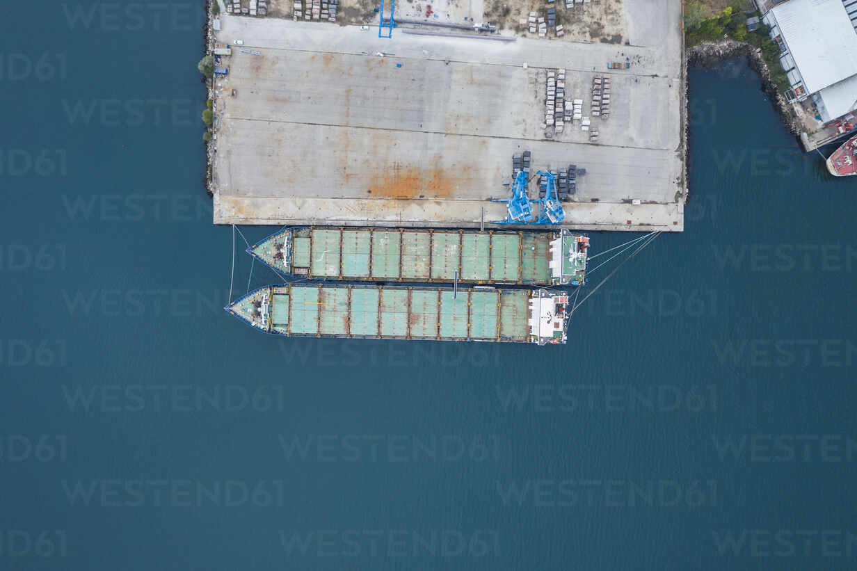 Drone View Of Container Ships Moored By Dock At Port On Blue Sea Rsgf Csshot Westend61